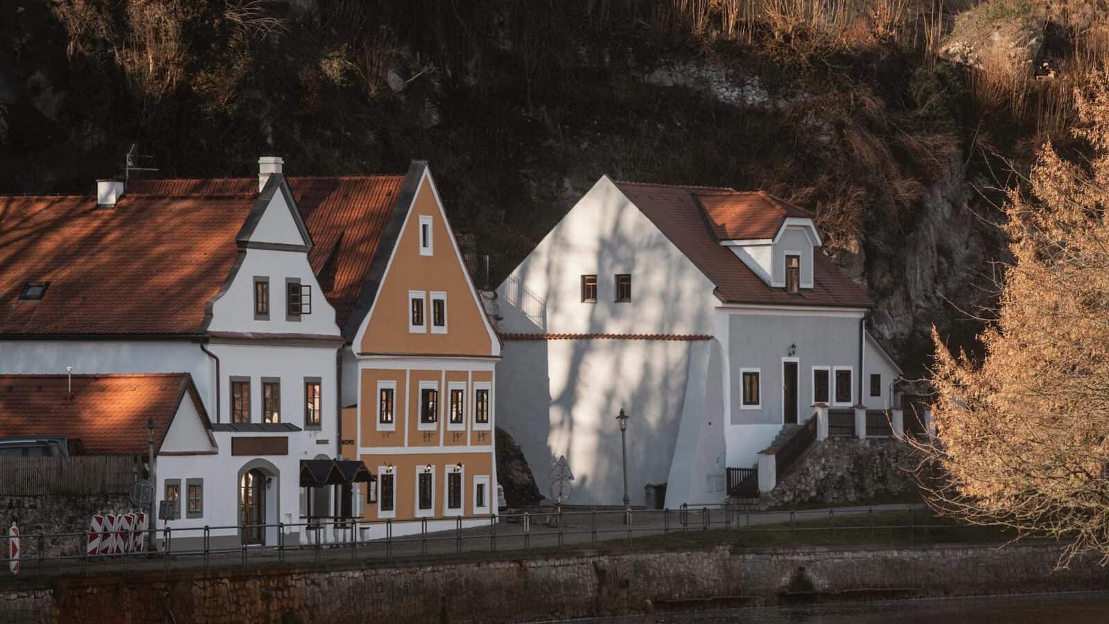 Village houses beside a river in autumn light